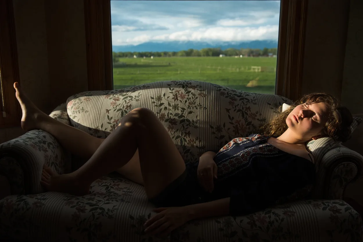 Young woman sleeping on sofa