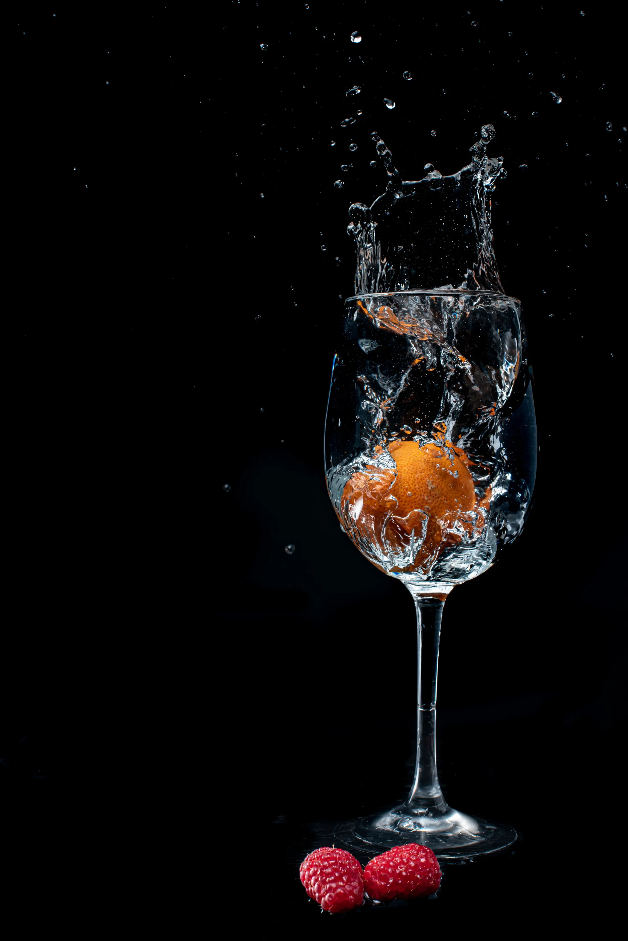 Fruits splashing in to the glass of water