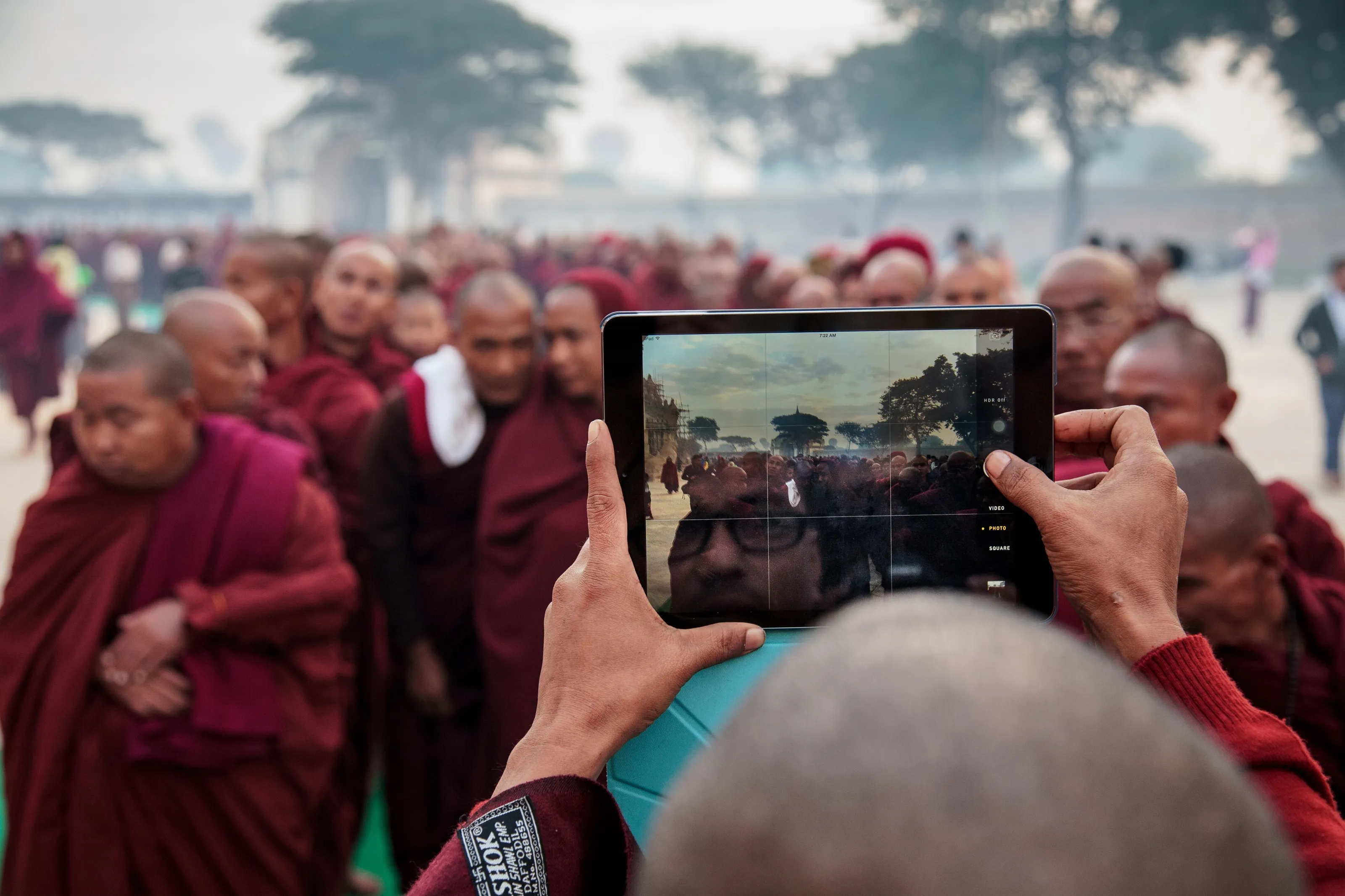 Monk takes a picture on his IPad at the Ananda pagoda festivals in Bagan.