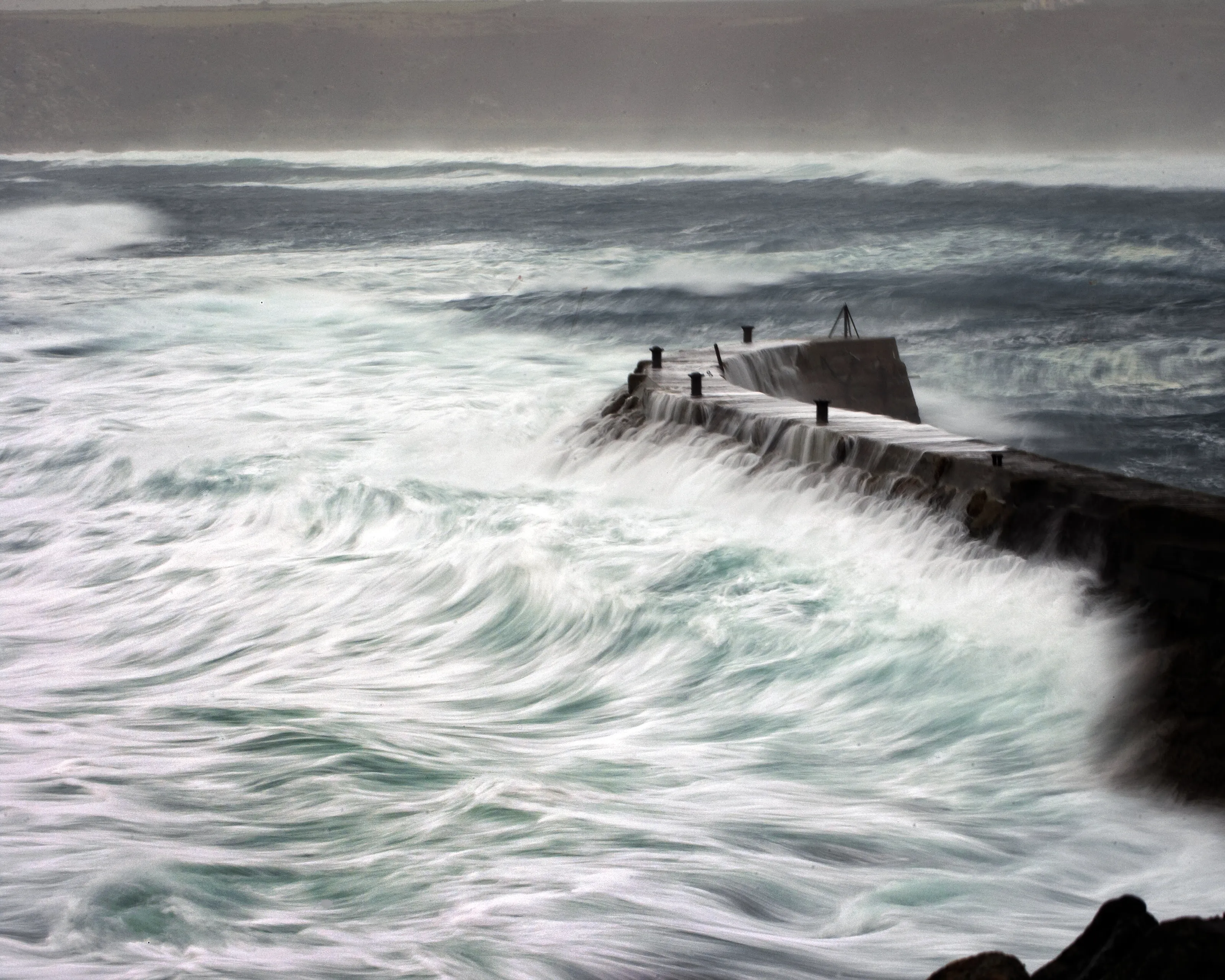Stormy sea with lashing rain, Sennen Cove, Cornwall, UK.