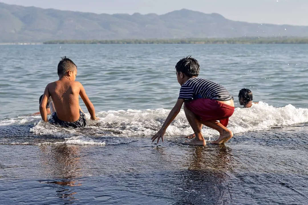 Children having fun in a fish port on a Sunday morning.