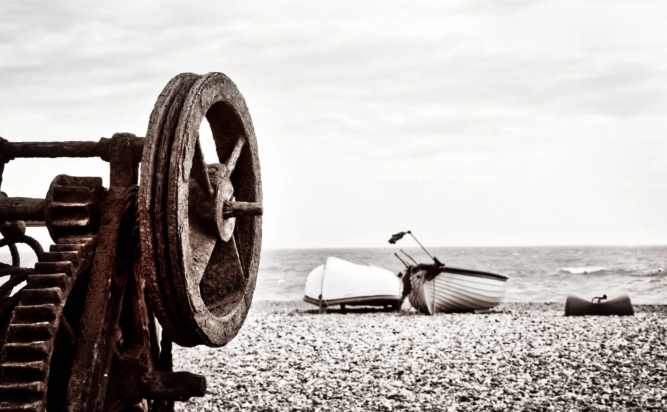 Rusted wheel on machine by the sea