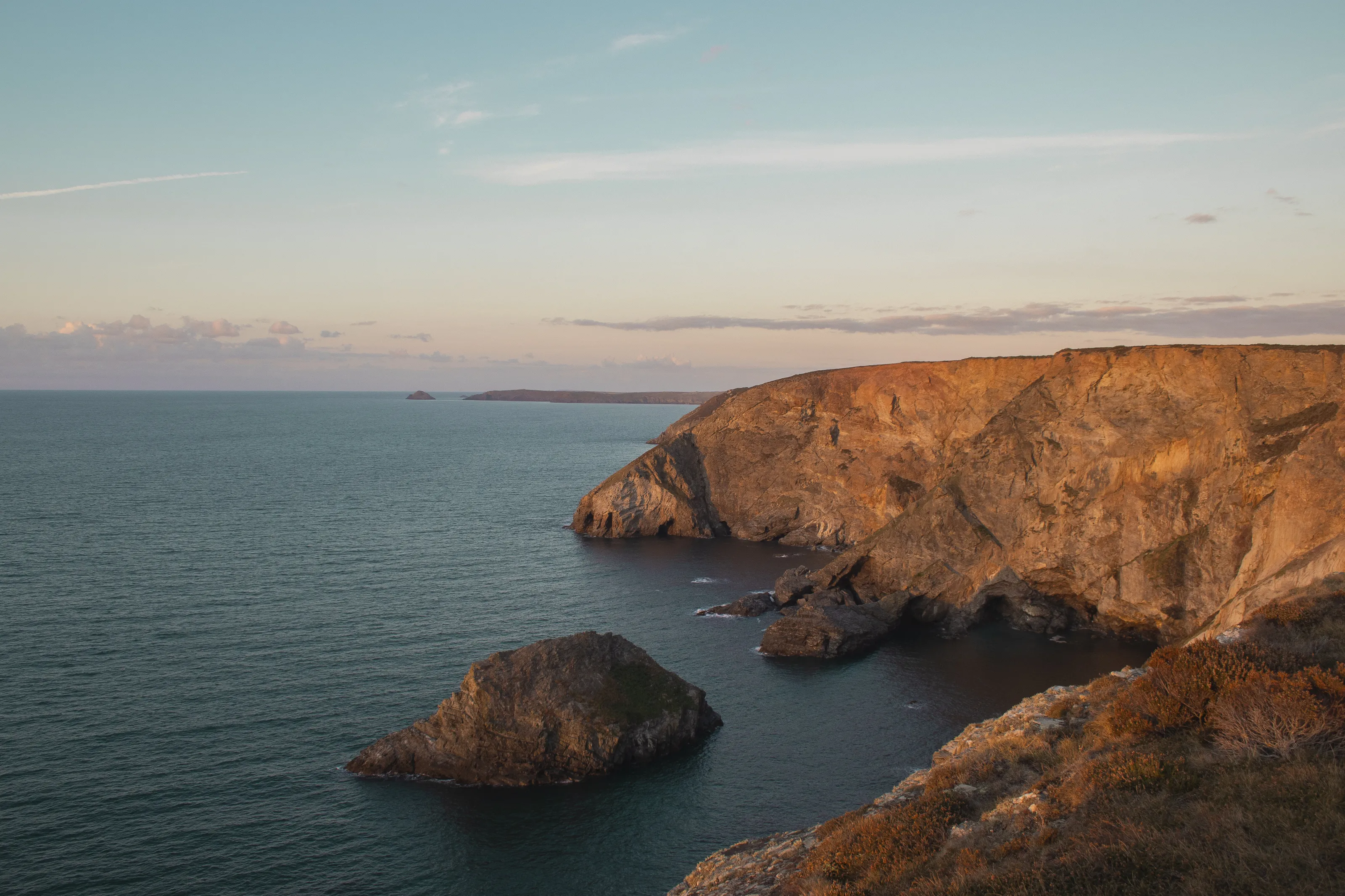 An autumn sunset glows over the Trevellas Cover coastal path.
