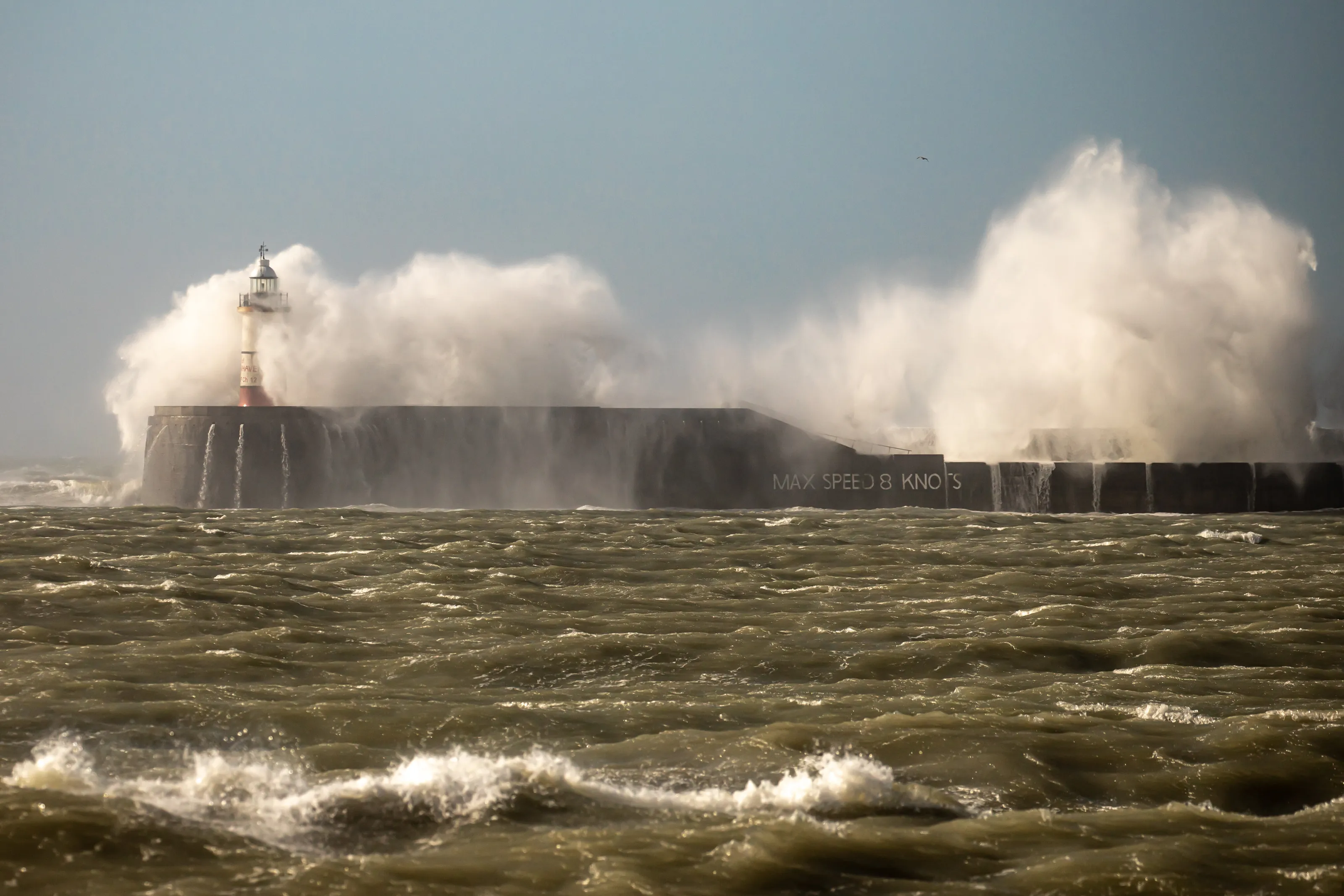 Waves breaking over the quay