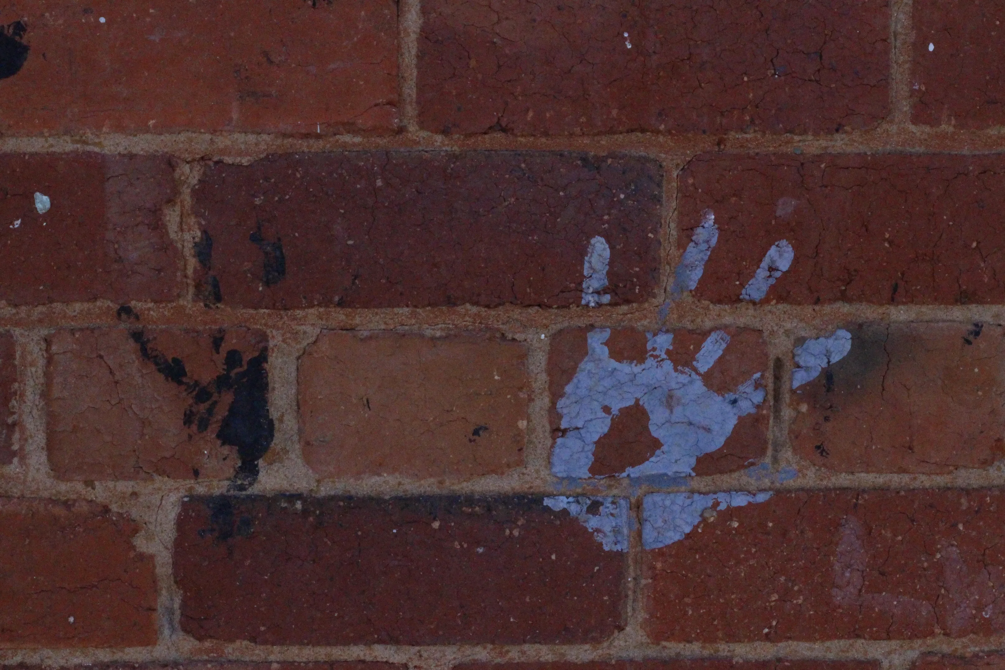Brick wall and hand print