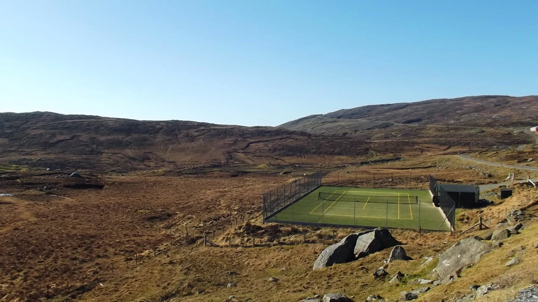 Empty tennis court, empty hills.