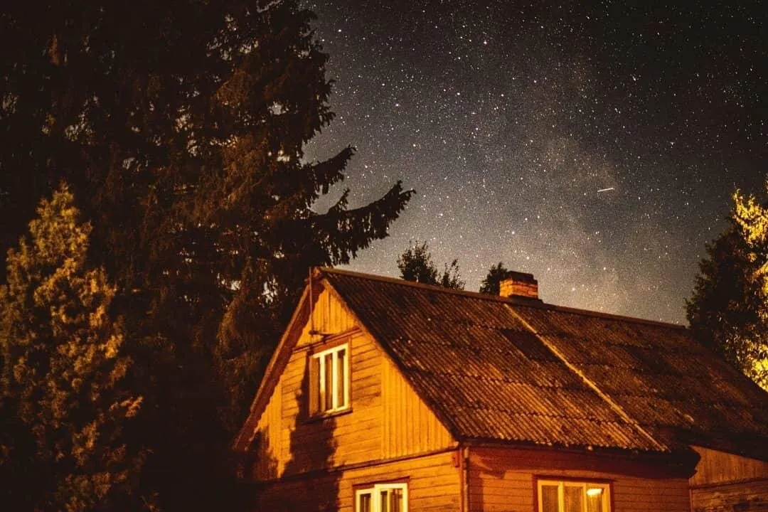 Stars over the house in middle of forest