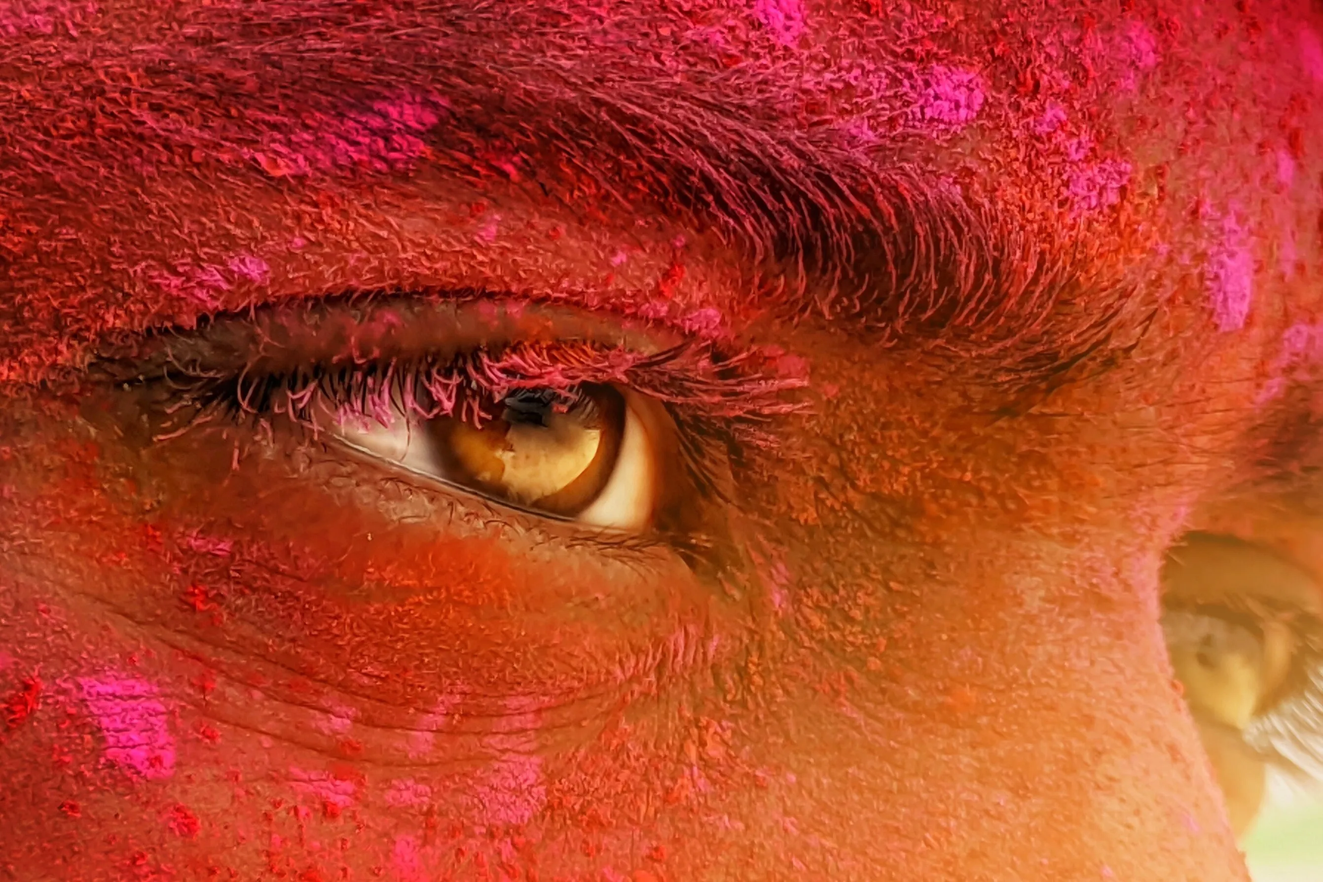 Close up shot of a male model with colours on his face