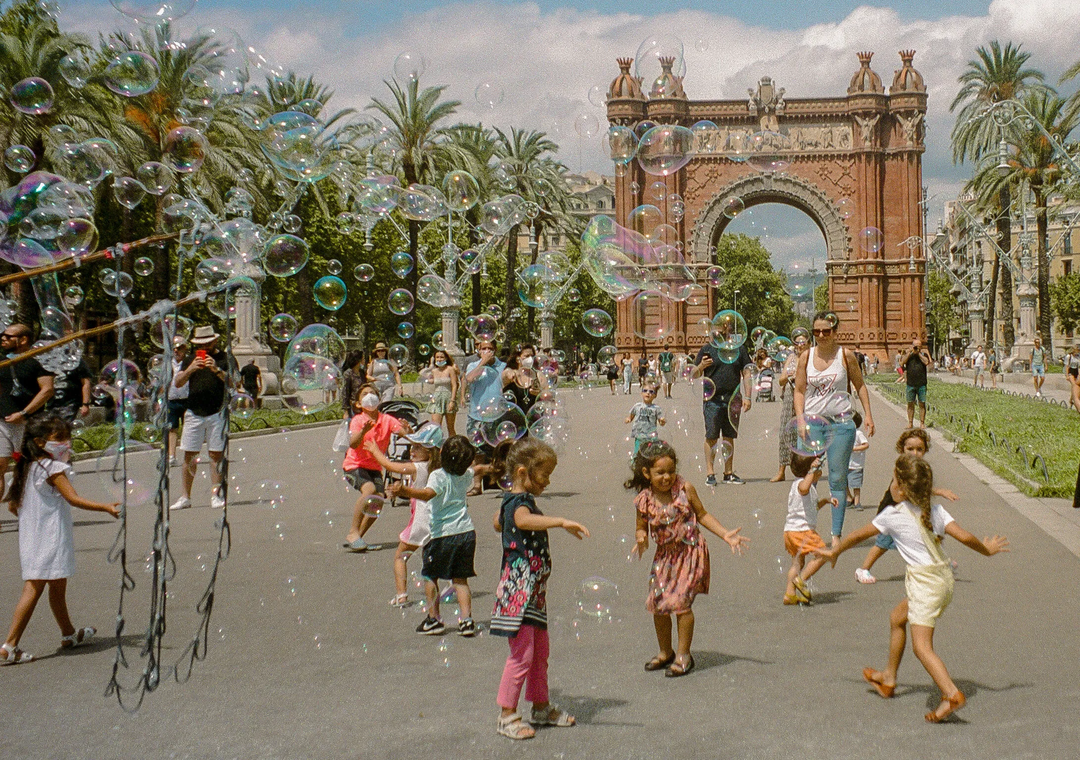 Children playing in front of the Arc De Triomphe in Barcelona
