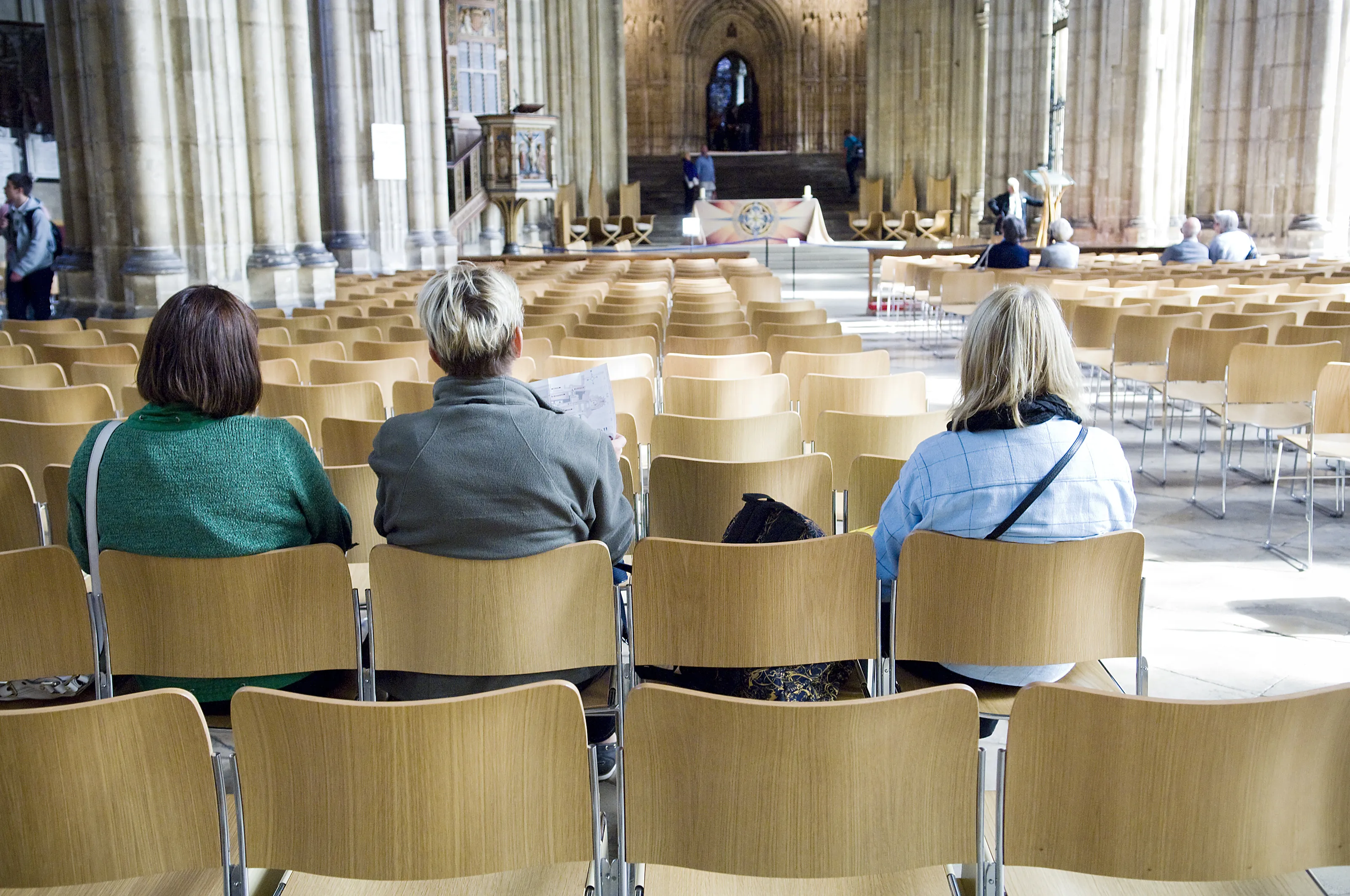 People sitting inside Canterbury Cathedral.