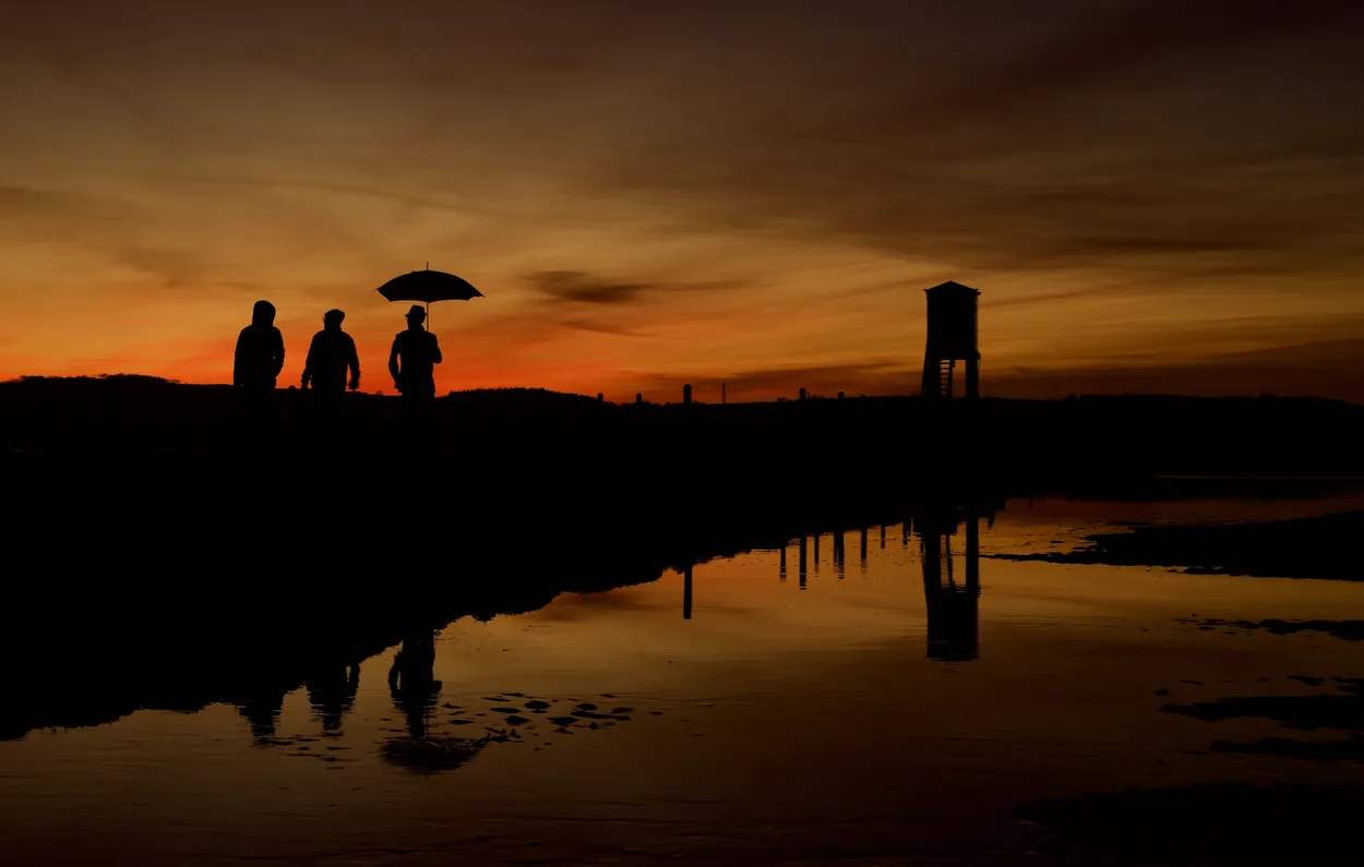 Sunset Stroll Along The Causeway ( a very popular location for birds, hence the umbrella ).
