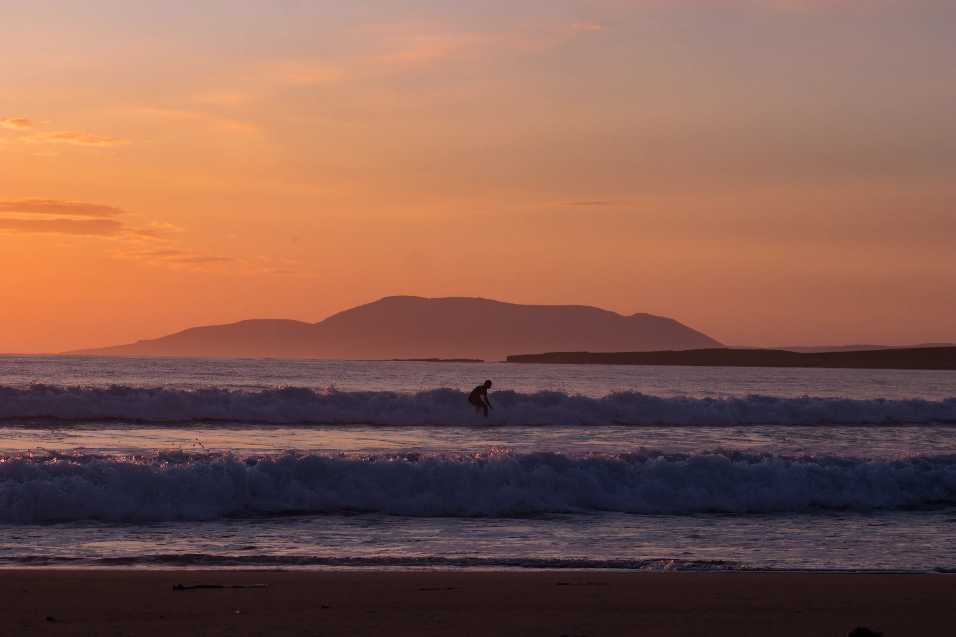 surfing at sunset