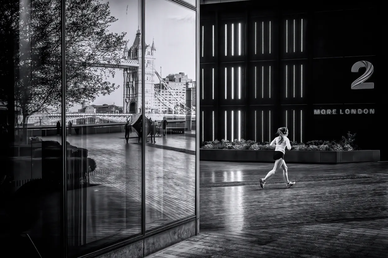 Running and reflections in London UK black and white