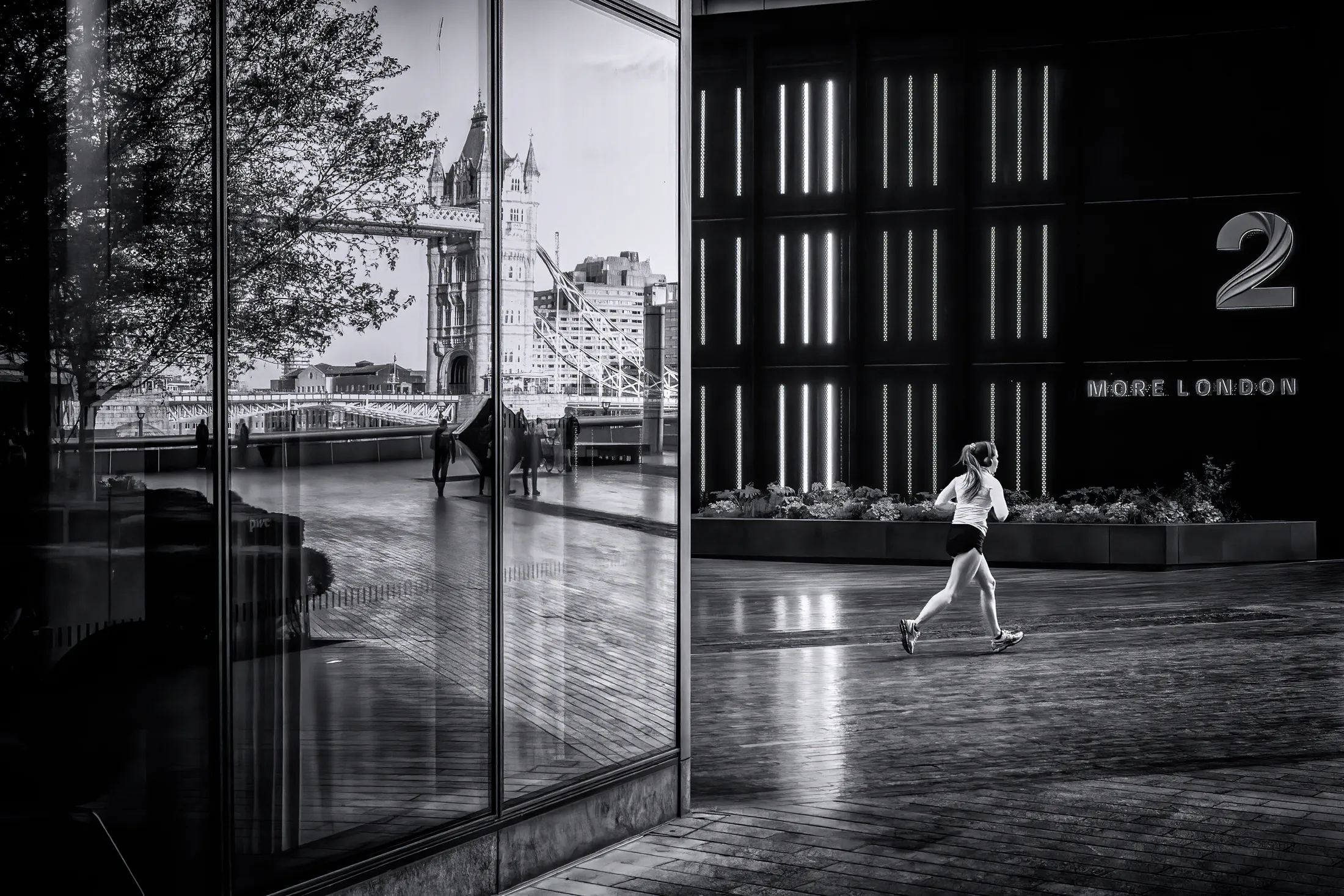Running and reflections in London UK black and white