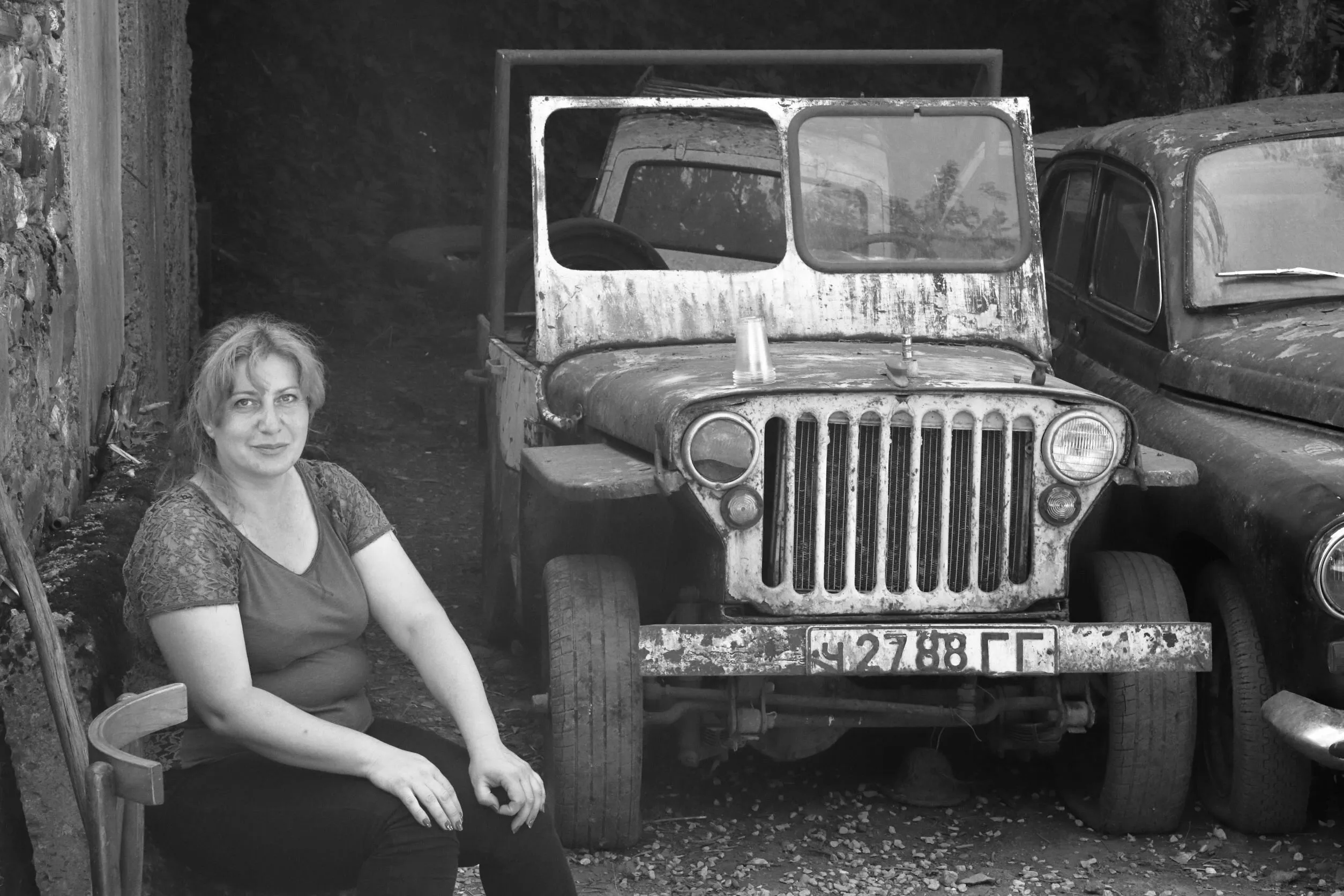 Georgia, Caucasus, Woman with old vehicles