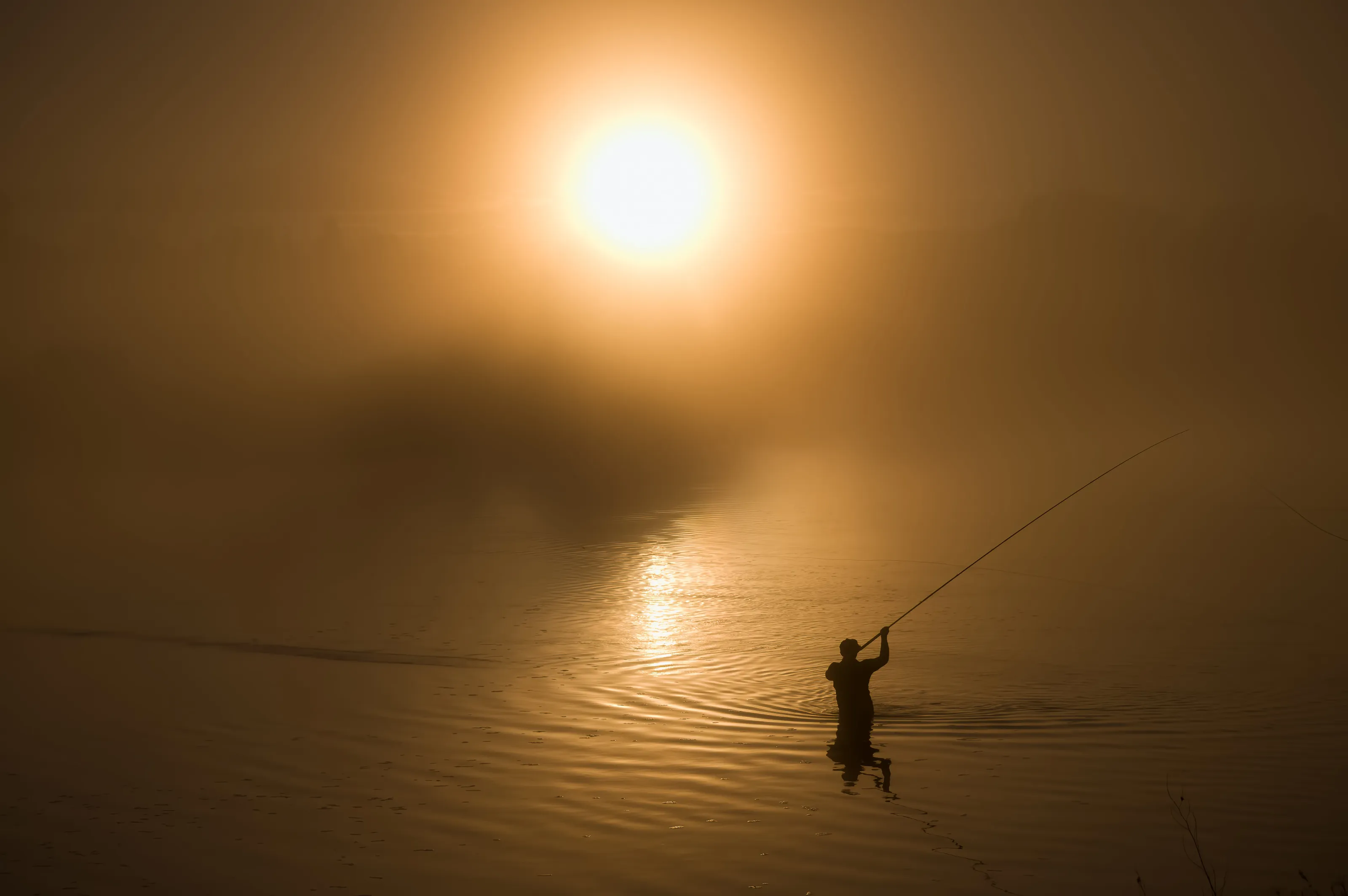 Fishing into the sunrise