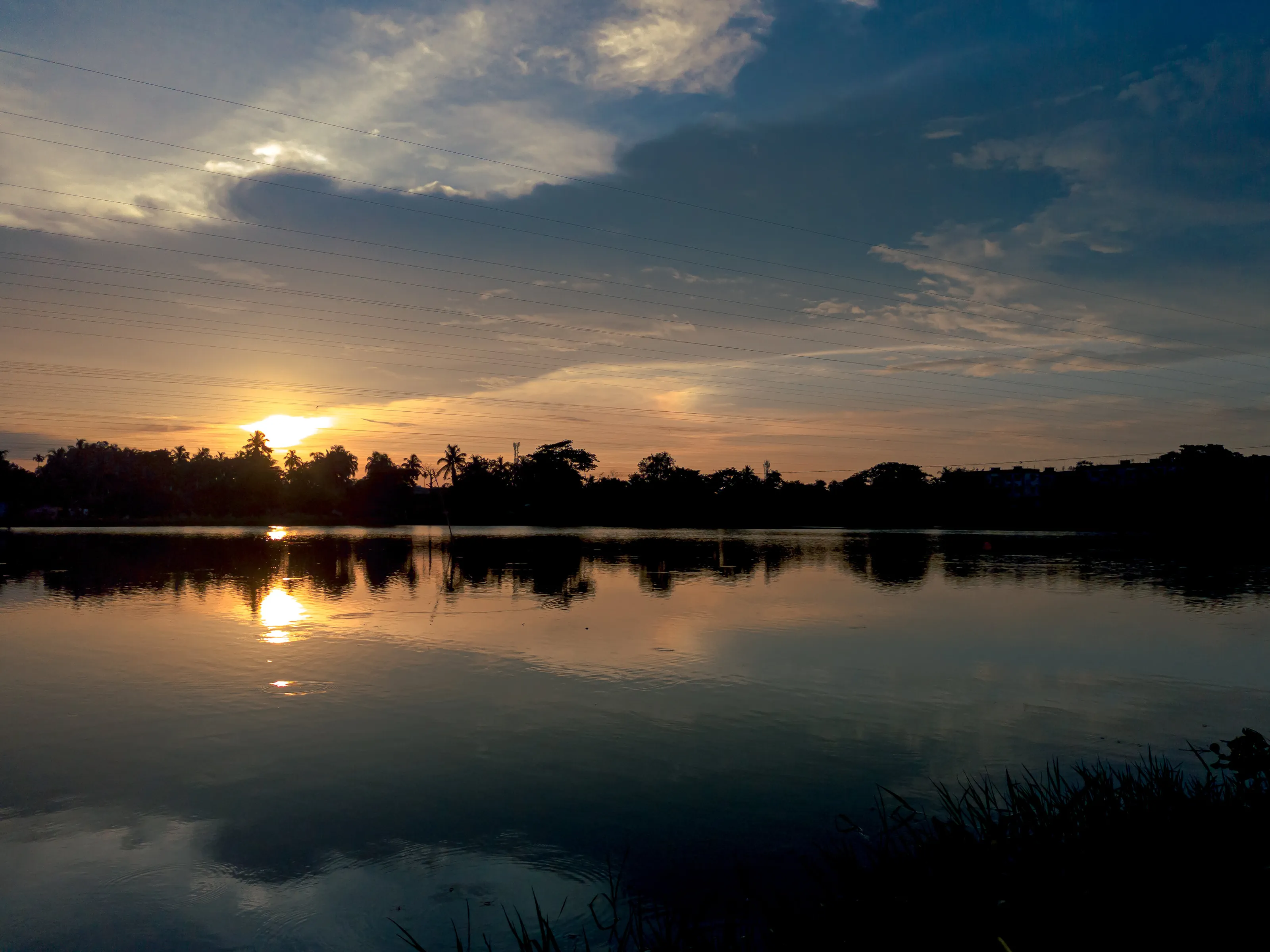 Sunset beside lake with clouds