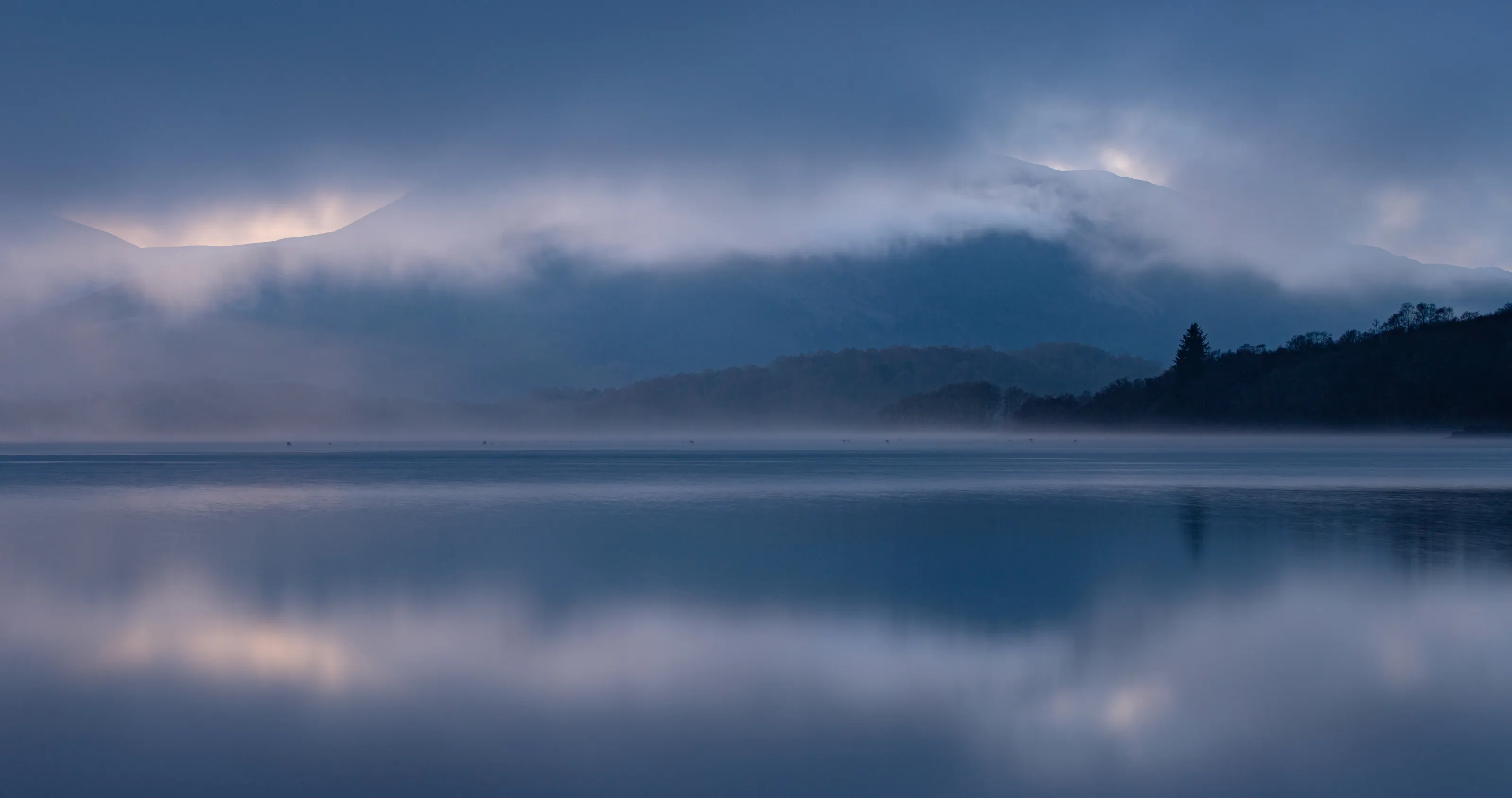 Sunset on a misty Loch Lomond