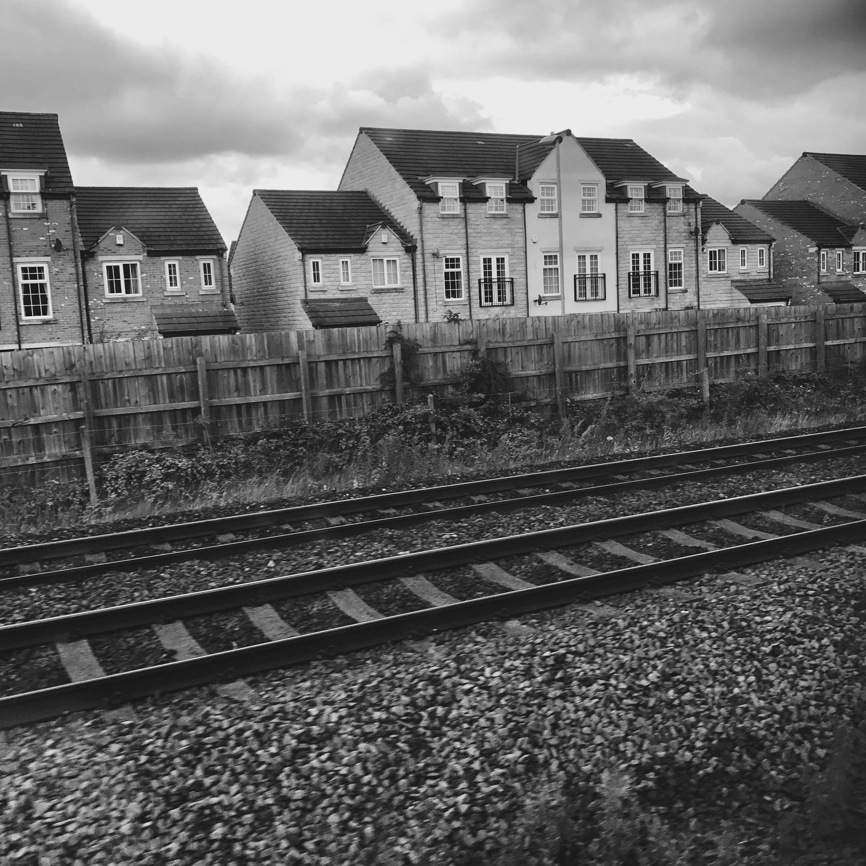 At the edge of the tracks.