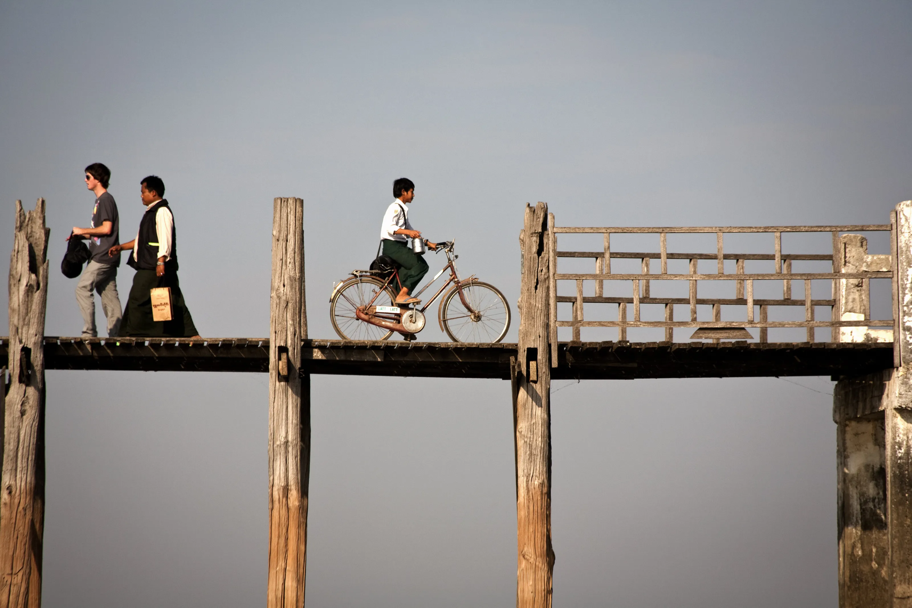 Cyclist and pedestrians on U Bein's wooden bridge Myanmar