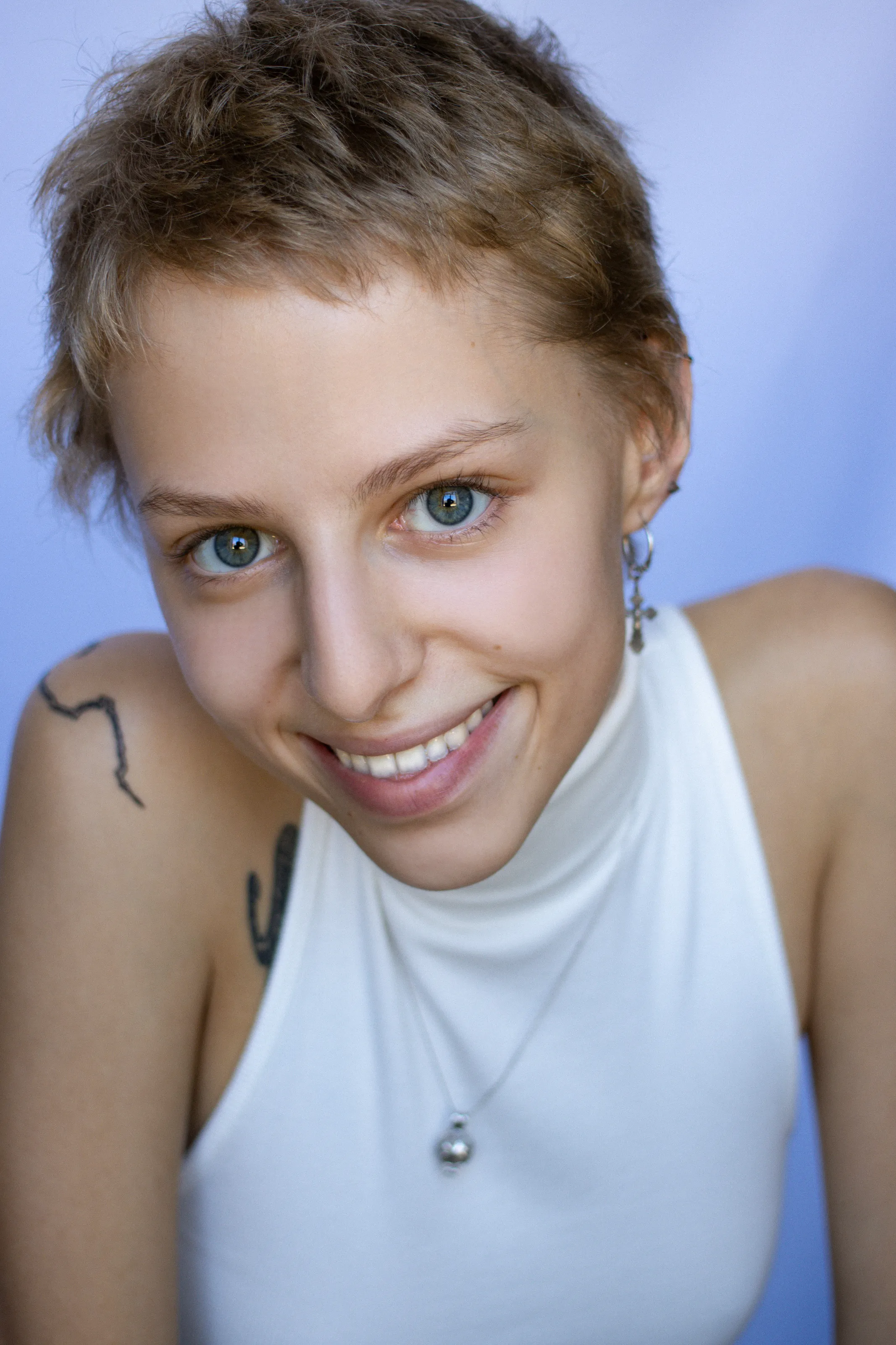 Blonde with short haircut and shoulder tattoo