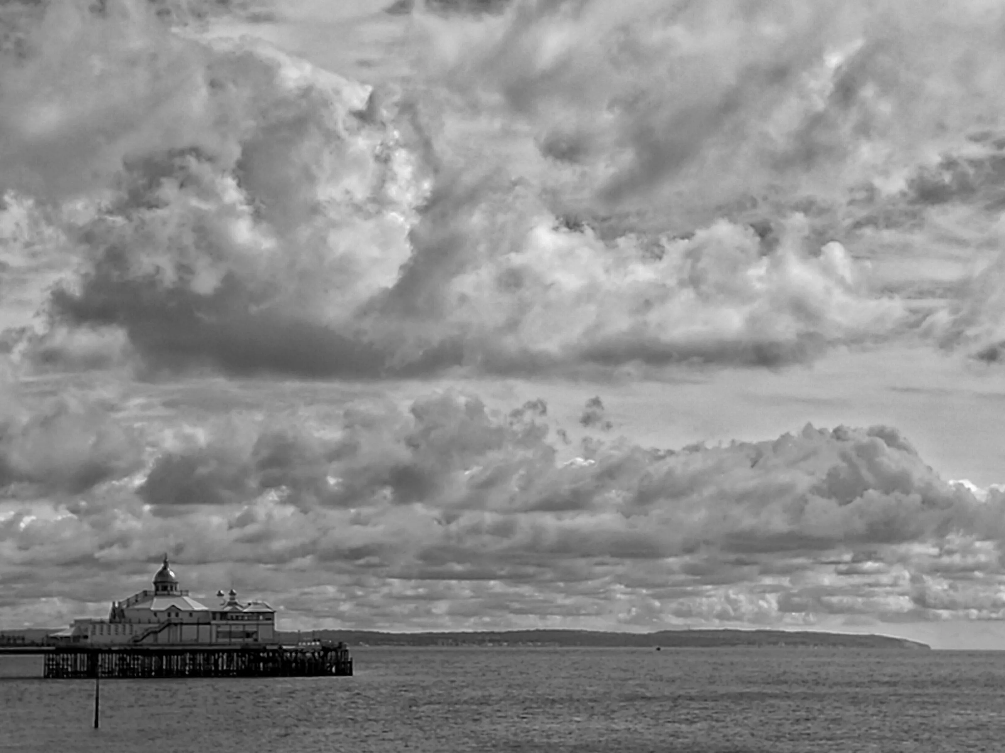 Eastbourne pier on a cloudy day in black and white