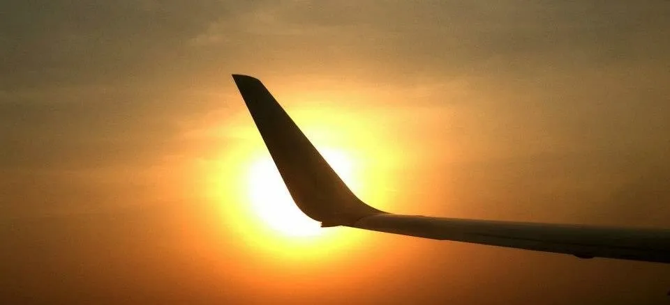 Sun Shining behind plane wing