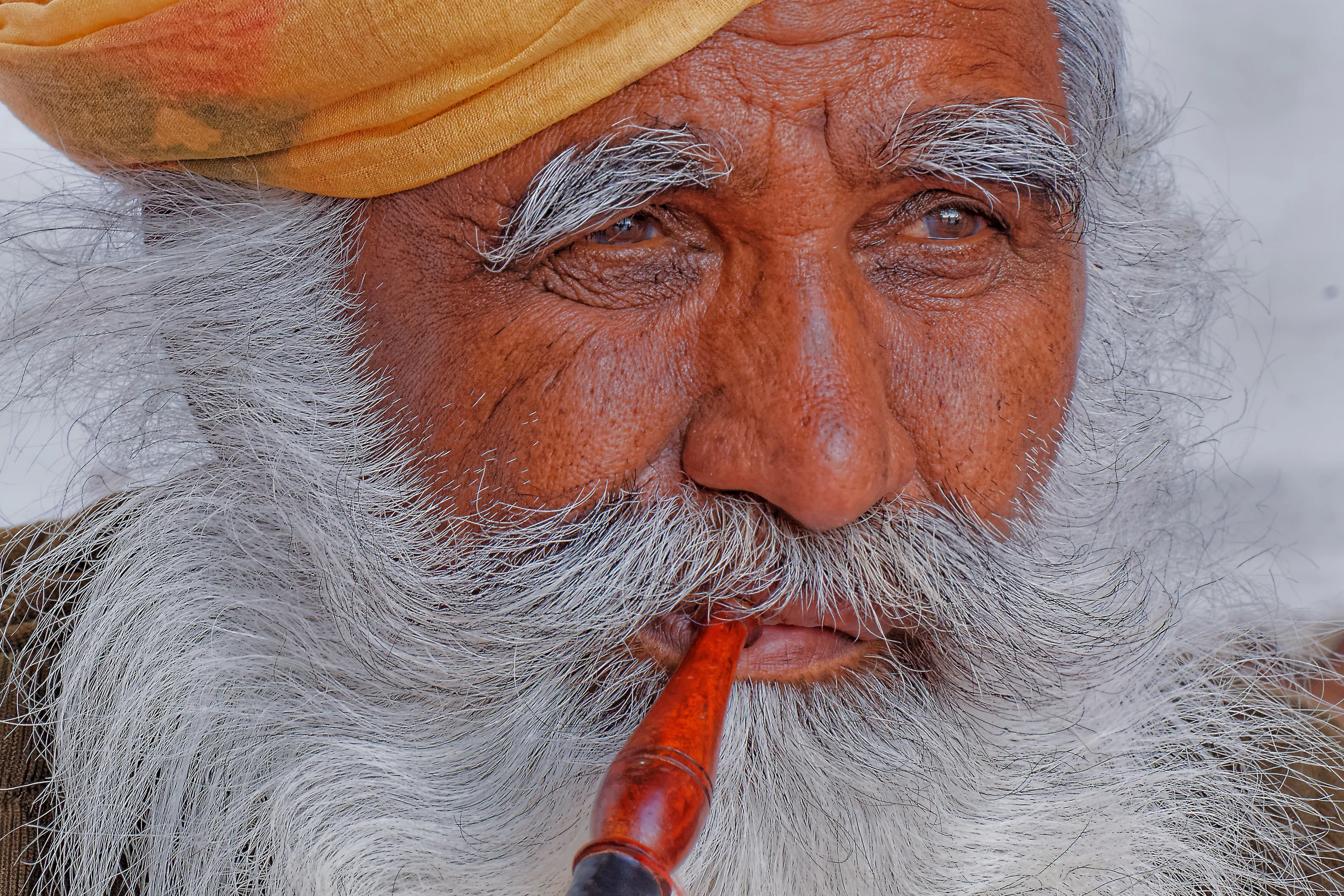 Old wise man smoking pipe