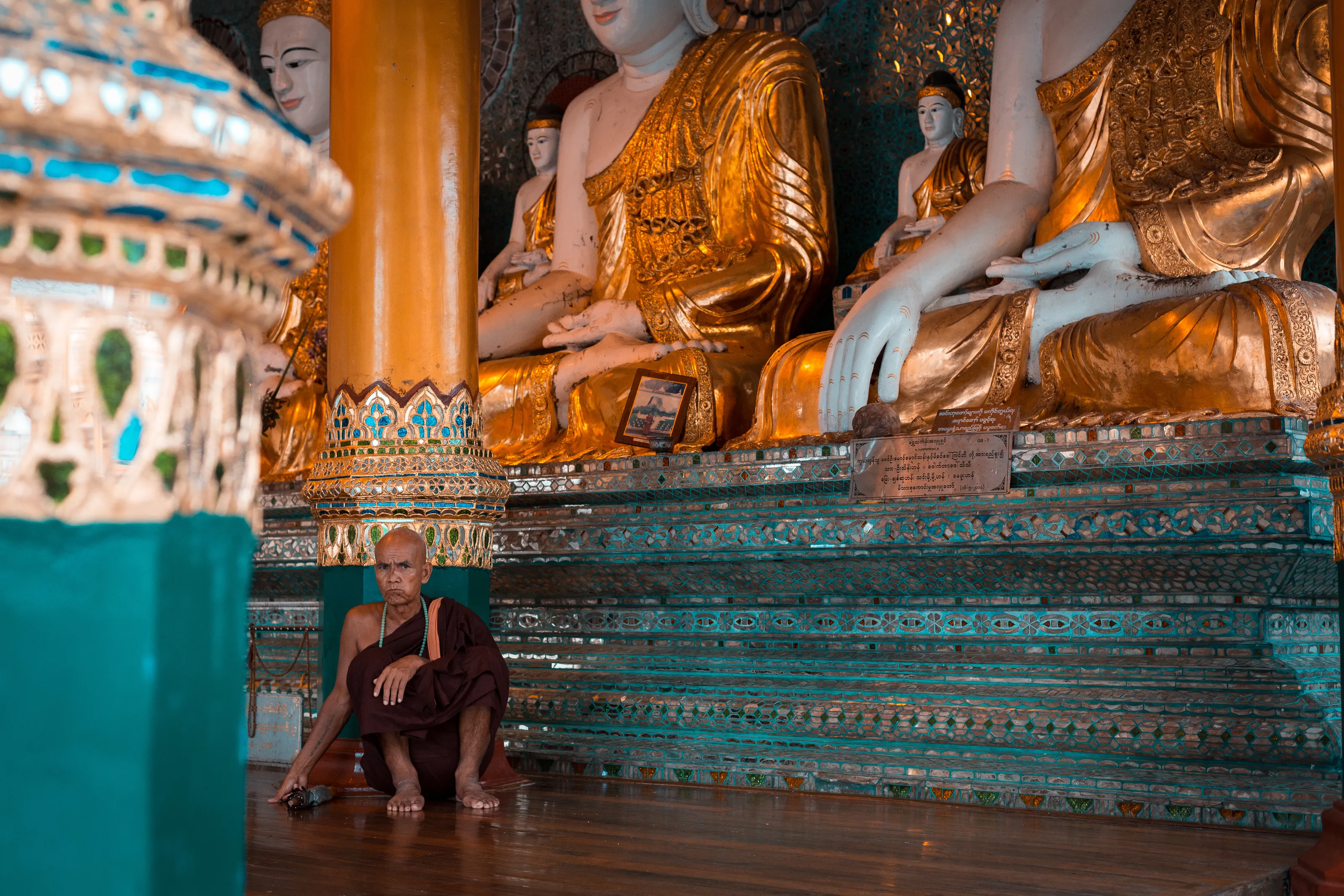 Staring Burmese Monk matching Earth Touching Buddhas' posture