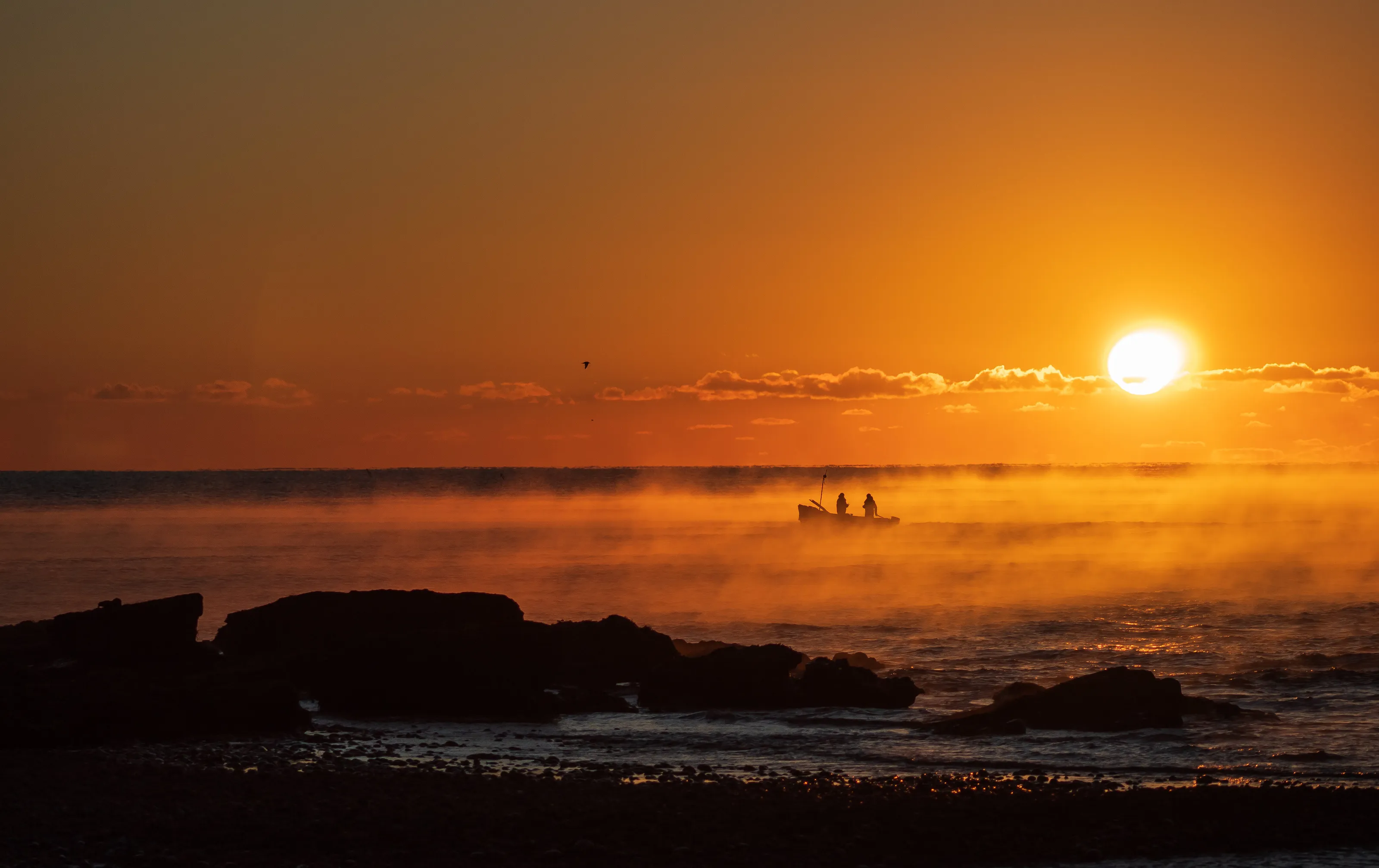 Misty sunrise and a fishermens boat
