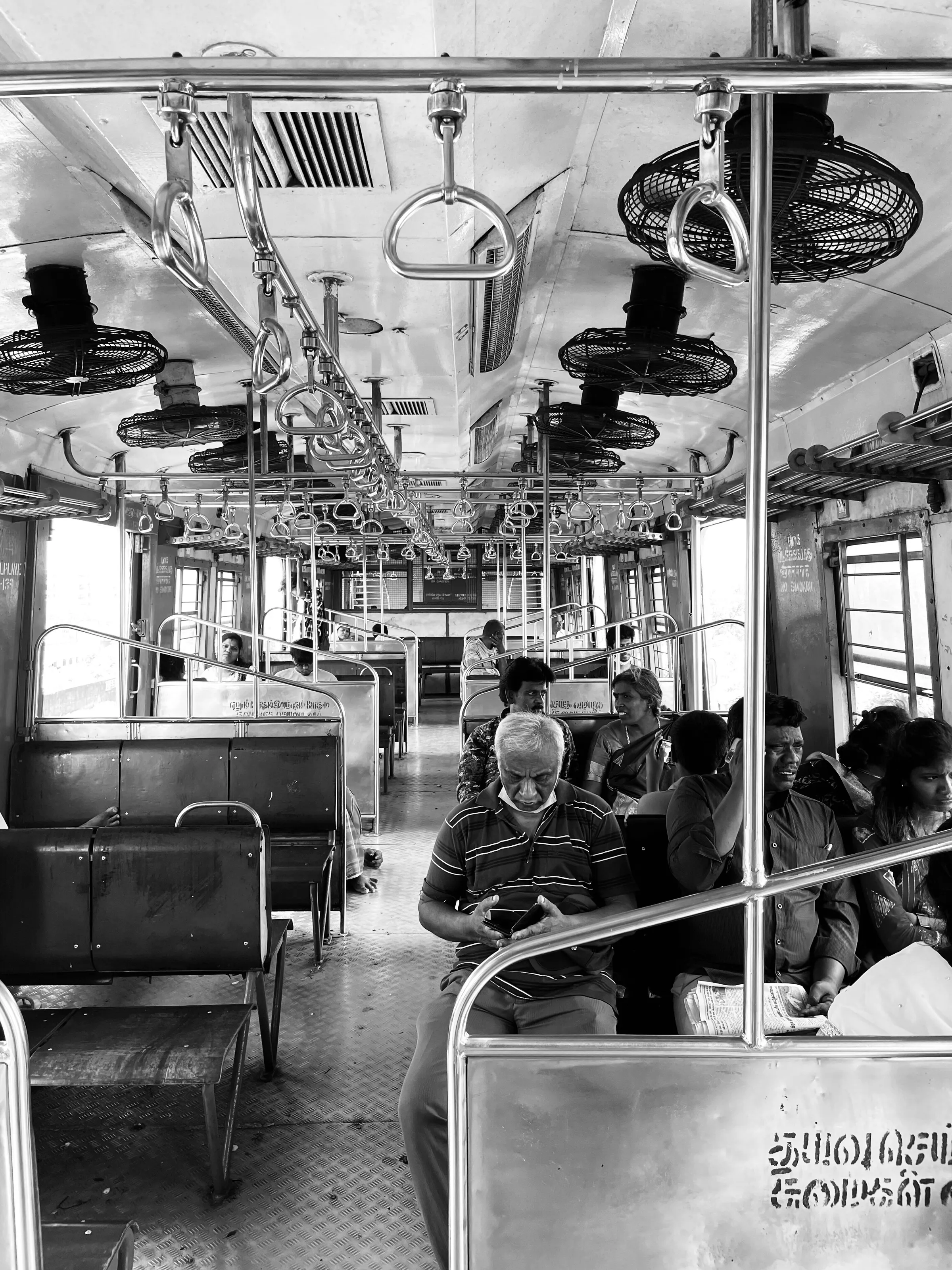 Each lost in their own world, yet bound by the journey's shared solitude.