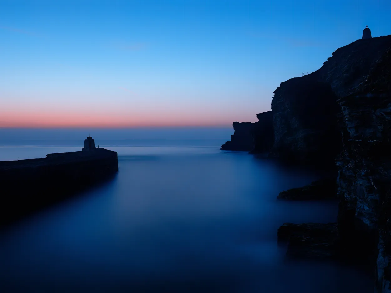 Silhouettes at Portreath Harbour slow exposure Cornwall UK