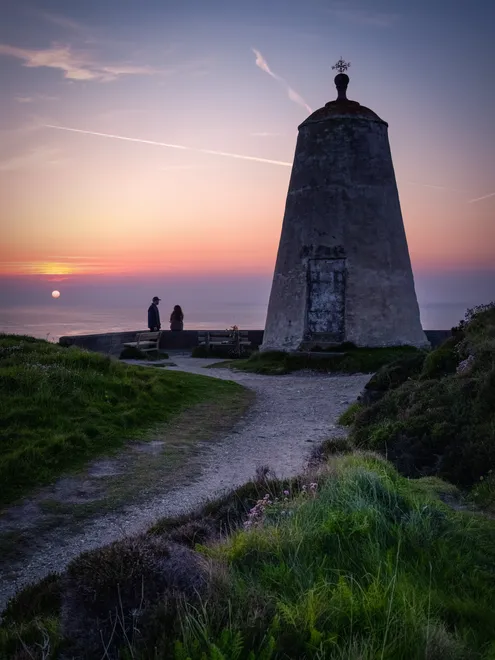 Silhouettes at the pepper pot Portreath at sunset cornwall uk