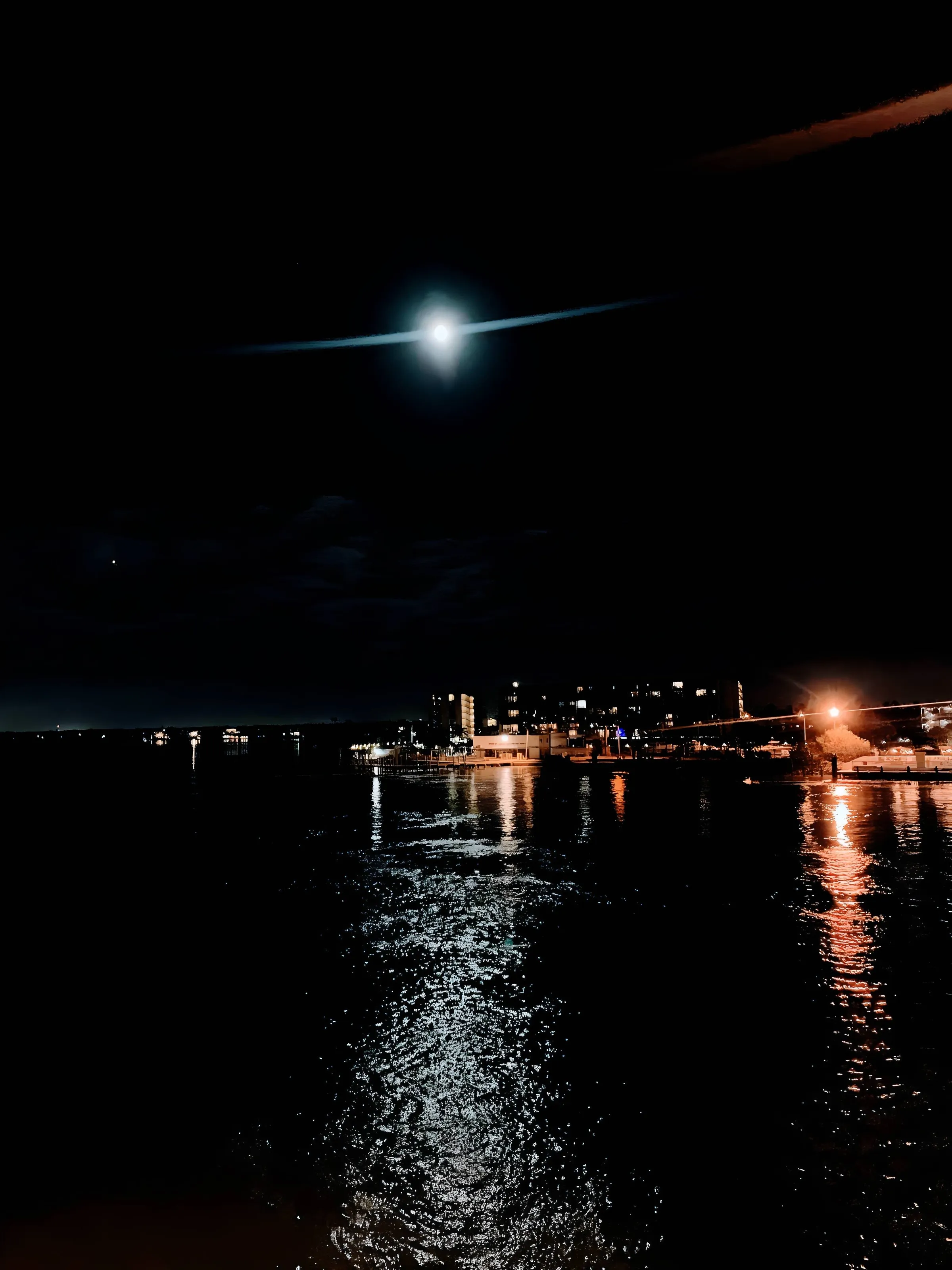 City over the night sky lit by the moon