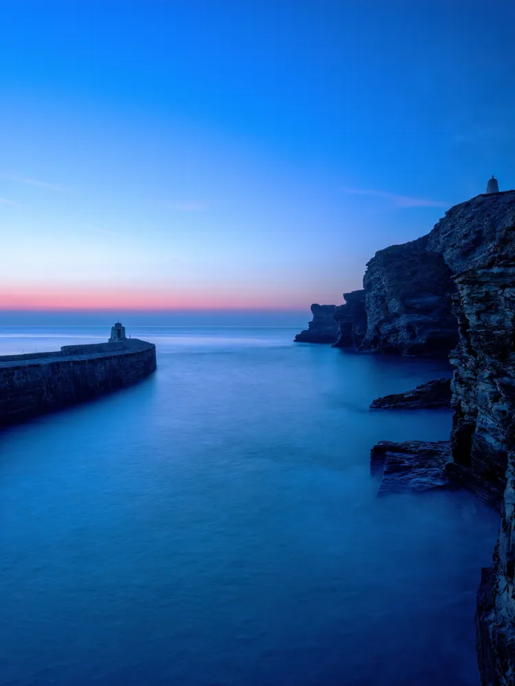 Portreath harbour at blue hour with the belt of Venus Cornwall uk seascape long exposure